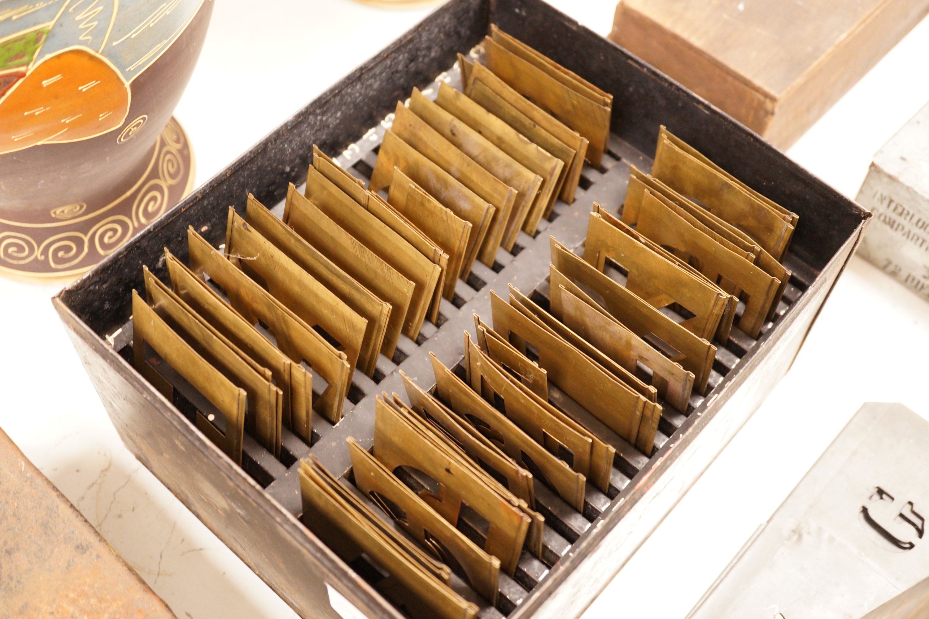A mixed collection of early 20th century brass and other alphabetical stencil plates, varying sizes